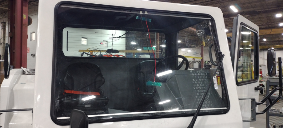 A photo of a white truck, showing the windshield glass.