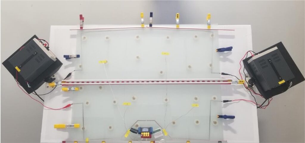 A photo of a glass panel being tested, with thermocouples.